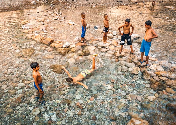 Local Berber Children Splashing in The Cool Mountain Streams (Dades Gorge)