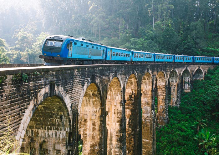 Trains pass through the Nine Arch Bridge