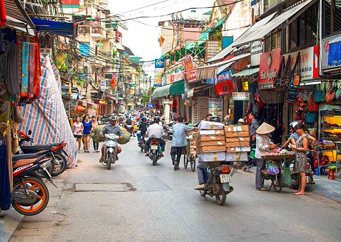 The motorbike weaves through a maze of narrow streets
