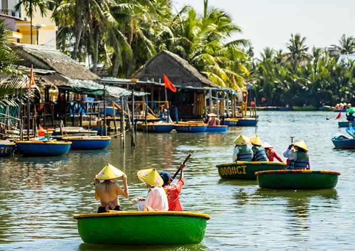 Glide through palms in a woven basket boat in Hoi An